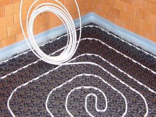 Fußbodenheizung im Noppenplattensystem – Eckansicht mit verlegten Noppenplatten und Rohr